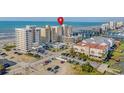 Oceanfront building and nearby beach, showing location at 6100 N Ocean Blvd. # 207, North Myrtle Beach, SC 29582