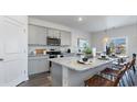 Modern kitchen with gray cabinets, granite countertops, and an island at 724 Wallace Dr., Little River, SC 29566