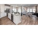 Open concept kitchen with island, stainless steel appliances, and adjacent living area at 1212 Arizona Dr., Longs, SC 29568