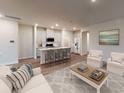 Open-concept living area with modern kitchen, island with bar seating, and comfortable lounge area at 1215 Arizona Dr., Longs, SC 29568