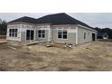 Rear view of house under construction, showing gray siding and a patio at 217 Shady Pines Ct., Conway, SC 29527