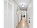 Bright hallway with tiled floor, white closet, and view into living area at 5200 N Ocean Blvd. # 1033, Myrtle Beach, SC 29577