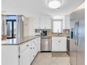 White kitchen cabinets, granite countertops, stainless steel appliances at 5910 N Ocean Blvd. # 504, North Myrtle Beach, SC 29582