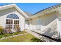 Front entryway with arched window and landscaping at 6028 Andros Ln., Murrells Inlet, SC 29576