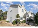 Side view of townhome showcasing landscaping and exterior features at 101 S Barnwell St. # 38-A, North Myrtle Beach, SC 29582