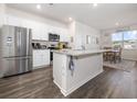 Modern kitchen with white cabinets, granite countertops, stainless steel appliances, and hardwood floors at 1143 Sennema Circle, Myrtle Beach, SC 29588