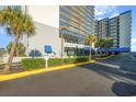 Well-lit parking area with lush landscaping and building access at 2001 S Ocean Blvd. # 1102, Myrtle Beach, SC 29577