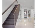 Modern staircase with dark wood and stainless steel railing at 305 S 21St Ave. S # 112, Myrtle Beach, SC 29577