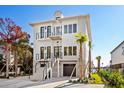 Modern three-story home with gray accents and a spacious driveway at 3109 First Ave. S, Murrells Inlet, SC 29576