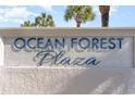 Ocean Forest Plaza building entrance sign with palm trees in the background at 5523 N Ocean Blvd. # 1812, Myrtle Beach, SC 29577
