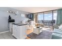 Living room with ocean view, balcony access, and comfortable seating at 5523 N Ocean Blvd. # 1812, Myrtle Beach, SC 29577