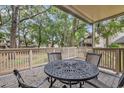 Deck with round metal table and chairs, overlooking a wooded area at 101 Westhill Circle # 5-C, Myrtle Beach, SC 29572