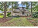 Two-story condo with balcony, surrounded by lush green trees and grass at 101 Westhill Circle # 5-C, Myrtle Beach, SC 29572