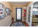 Bright and spacious entryway with decorative door and hardwood floors at 126 Lakeside Crossing Dr., Conway, SC 29526