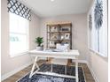 Bright home office features built-in shelving and hardwood floors at 2709 Rowyn St., Longs, SC 29568