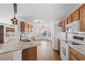 Modern kitchen with granite countertops, wooden cabinets, and stainless steel appliances at 2053 Haystack Way, Myrtle Beach, SC 29579