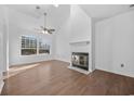 Living room with hardwood floors, fireplace, and large window at 310 Lakeside Dr. # C, Surfside Beach, SC 29575