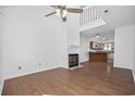 Living room with hardwood floors, fireplace, and high ceiling at 310 Lakeside Dr. # C, Surfside Beach, SC 29575