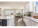 Open concept kitchen with island, white cabinets and view to dining area at 534 Slaty Dr., Myrtle Beach, SC 29588