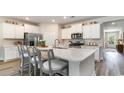 Modern kitchen island with white cabinets and quartz countertops at 6040 Forest Dell Ct, Myrtle Beach, SC 29579