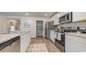 White kitchen with stainless steel appliances and granite countertops at 71 Arbor Crest Ln., Tabor City, NC 28463