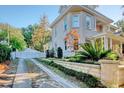 Private driveway with white gate leading to a charming stone home at 116 Saint James St., Georgetown, SC 29440