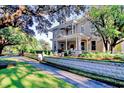 Two-story home with stone exterior, large porch, and lush landscaping at 116 Saint James St., Georgetown, SC 29440