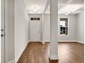 Bright entryway with hardwood floors, white door, and views into the living area at 1225 Nw Calabash Station Blvd., Calabash, NC 28467