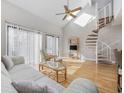 Bright and airy living room features a spiral staircase and vaulted ceilings at 1881 Colony Dr. # 8J, Myrtle Beach, SC 29575