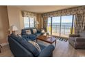 Living room with ocean view, comfortable seating, and balcony access at 2200 N Ocean Blvd., North Myrtle Beach, SC 29582