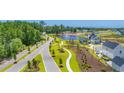Aerial view of a residential community with roads and a pond at 2218 Vera Way, Longs, SC 29568
