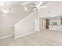 Bright living room with high ceilings, ceiling fan, and access to the kitchen at 230 Pilot House Pl. # 230, Carolina Shores, NC 28467