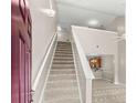 Interior view of a carpeted staircase leading to an open living area at 230 Pilot House Pl. # 230, Carolina Shores, NC 28467