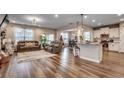 Open living space with hardwood floors, fireplace, and kitchen island at 5433 Merrywind Ct., Myrtle Beach, SC 29579