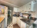 Clean and efficient kitchen featuring white cabinets and dark countertops at 6001 S Kings Hwy., Myrtle Beach, SC 29575