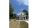 Newly built two-story home with white siding and a spacious lawn at 908 Merriman Rd., Georgetown, SC 29440