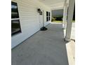 Covered front porch with concrete flooring and columns at 908 Merriman Rd., Georgetown, SC 29440