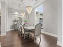 Elegant dining room with hardwood floors and a crystal chandelier at 9451 Bellasera Circle, Myrtle Beach, SC 29579