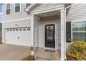 Inviting front entrance with a black door, wreath, and decorative columns at 326 H High Falls Dr., Conway, SC 29526