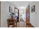 Bright entryway with tile floor, console table, and view to living area at 4800 S Ocean Blvd. # 412, North Myrtle Beach, SC 29582
