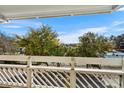 Balcony view overlooking tennis courts and trees at 1100 Possum Trot Rd. # E235, North Myrtle Beach, SC 29582