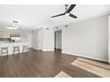 Open living area with wood-look flooring, ceiling fan, and view of the kitchen at 1100 Possum Trot Rd. # E235, North Myrtle Beach, SC 29582