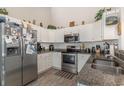Well-equipped kitchen with stainless steel appliances, ample counter space, and white cabinets at 239 Coachman Dr., Pawleys Island, SC 29585