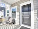Close-up of the front porch featuring a dark front door and white siding at 268 Empyrean Circle, Myrtle Beach, SC 29588