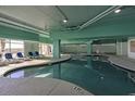 Indoor pool area with lounge chairs and natural light at 2801 S Ocean Blvd. # 1237, North Myrtle Beach, SC 29582