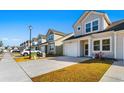 Row of townhouses showcasing contemporary style, gray siding, and attached garages at 351 Brackish Dr. # 351, Myrtle Beach, SC 29588