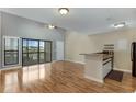 Bright living room with hardwood floors, access to a balcony, and an open kitchen at 4486 Little River Inn Ln. # 2105, Little River, SC 29566