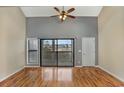 Living room with hardwood floors and sliding doors leading to a balcony at 4486 Little River Inn Ln. # 2105, Little River, SC 29566
