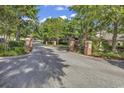 Gated entrance to a community with brick columns and lush landscaping at 601 N Hillside Dr. # 2034, North Myrtle Beach, SC 29582