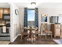 Dining area with a table and chairs next to a window with city views at 6804 N Ocean Blvd. # 1215, Myrtle Beach, SC 29572